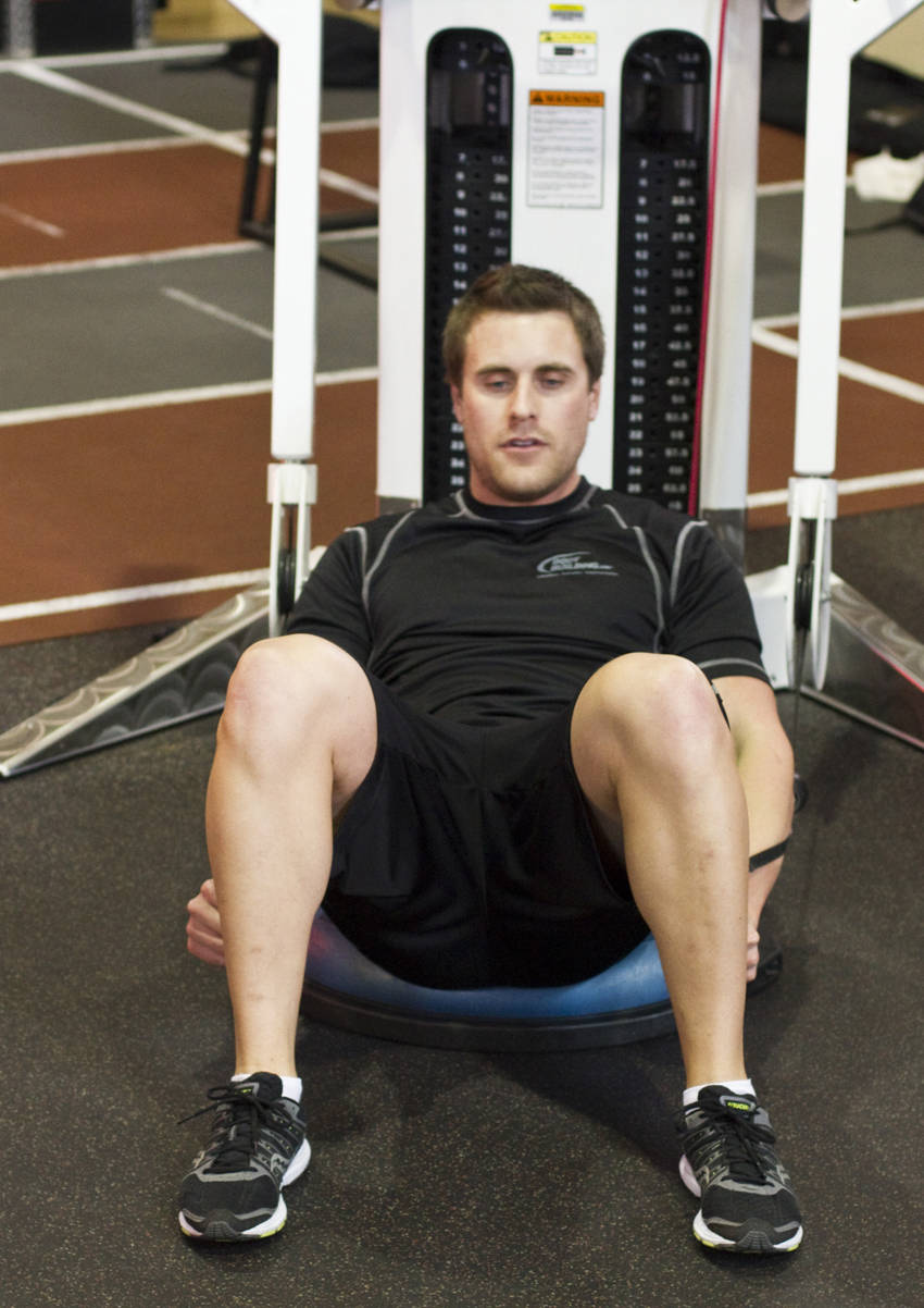 How to perform the Bosu Ball Cable Crunch With Side Bends exercise