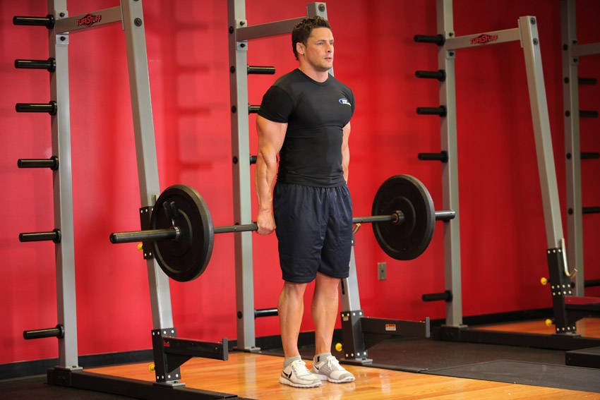 How to perform the Barbell Shrug Behind The Back exercise