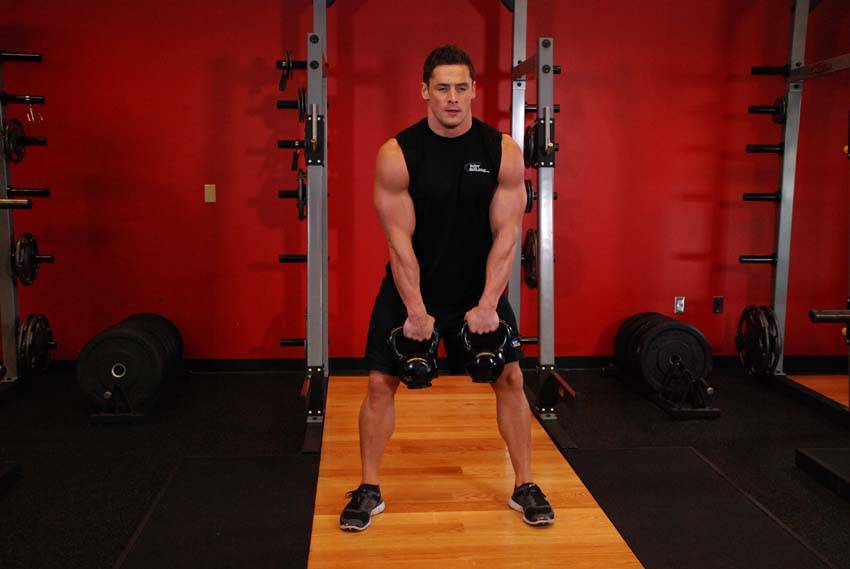 How to perform the Double Kettlebell Alternating Hang Clean exercise