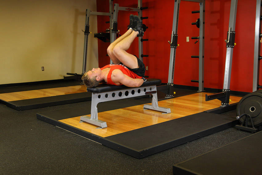 How to perform the Flat Bench Leg Pull-In exercise