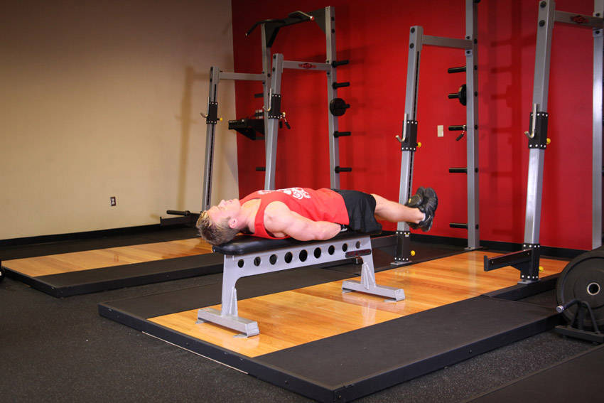 How to perform the Flat Bench Lying Leg Raise exercise
