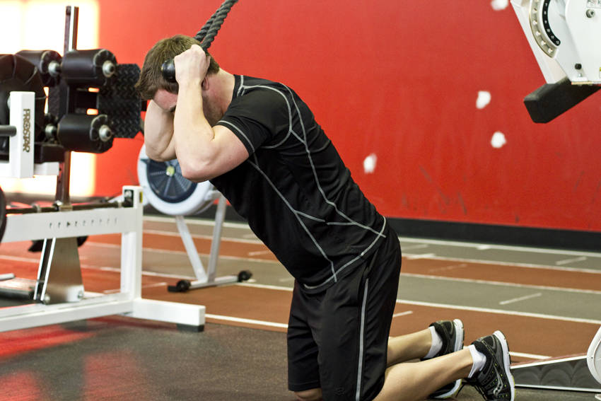 How to perform the Kneeling Cable Crunch With Alternating Oblique Twists exercise