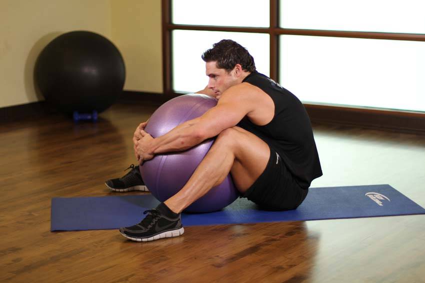 How to perform the Hug A Ball exercise