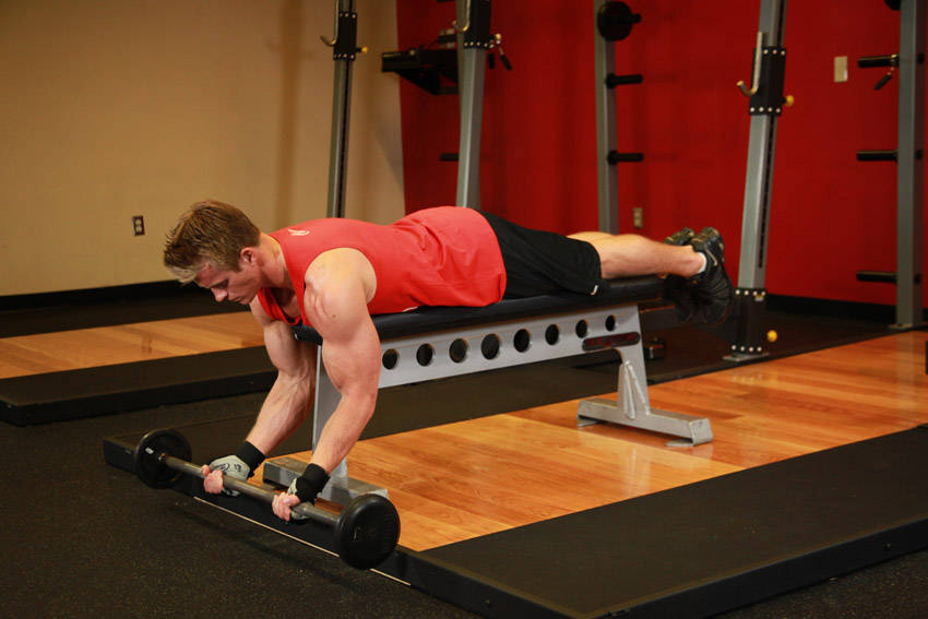 How to perform the Lying High Bench Barbell Curl exercise