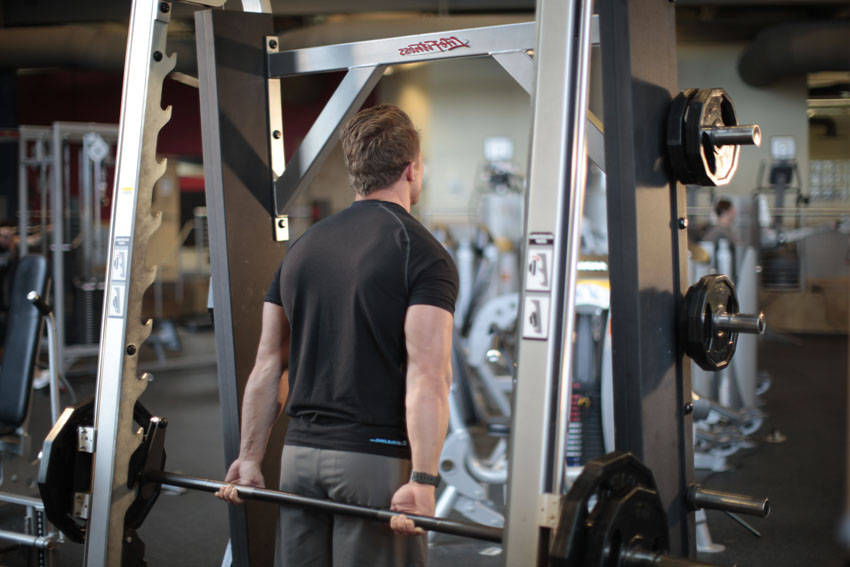 How to perform the Smith Machine Behind the Back Shrug exercise