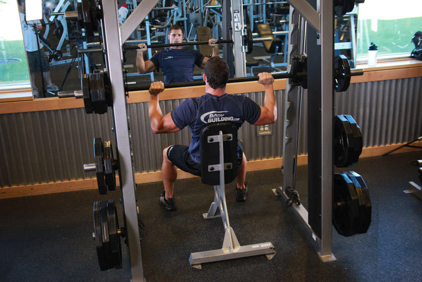 How to perform the Smith Machine Overhead Shoulder Press exercise