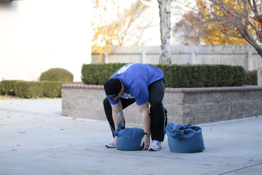How to perform the Sandbag Load exercise