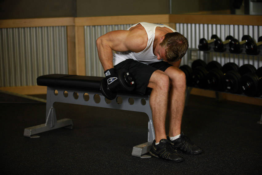 How to perform the Seated Bent-Over One-Arm Dumbbell Triceps Extension exercise