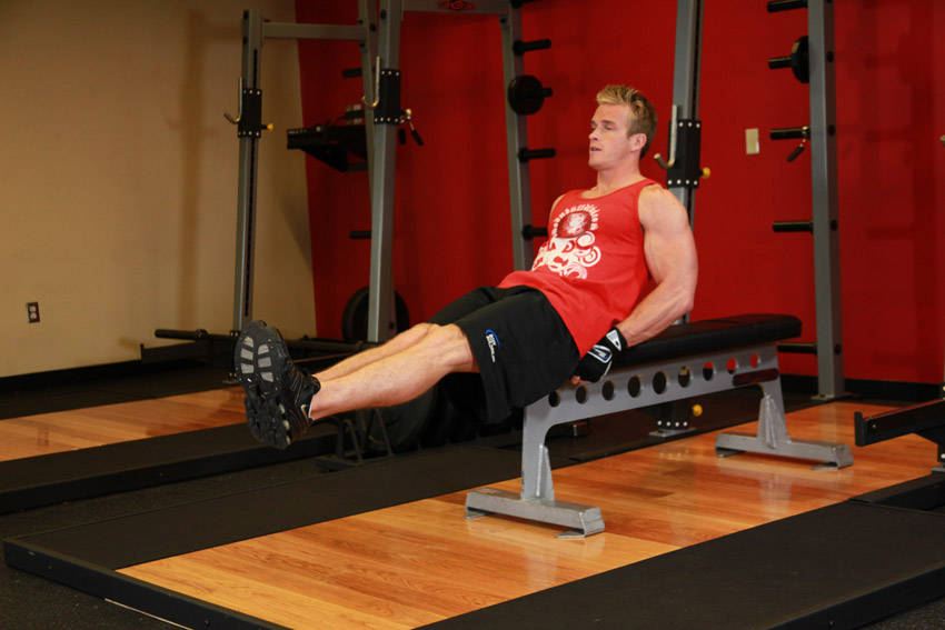 How to perform the Seated Flat Bench Leg Pull-In exercise