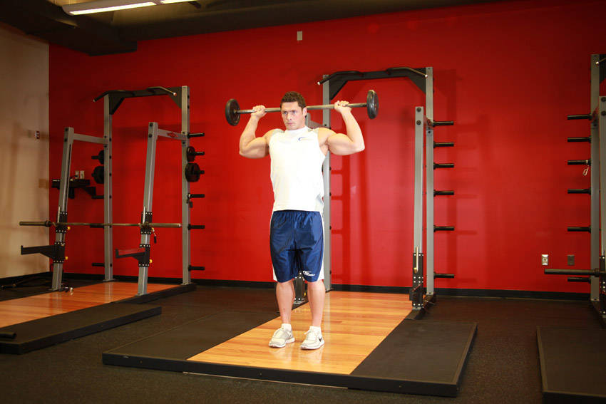 How to perform the Standing Barbell Press Behind Neck exercise