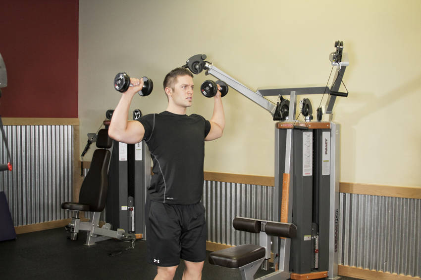How to perform the Standing Dumbbell Press exercise