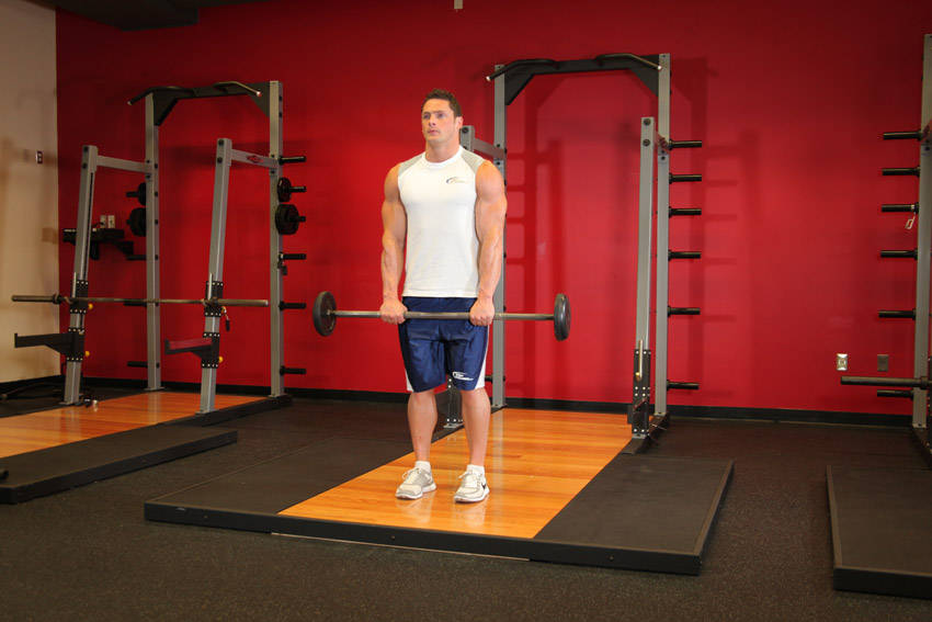 How to perform the Standing Front Barbell Raise Over Head exercise