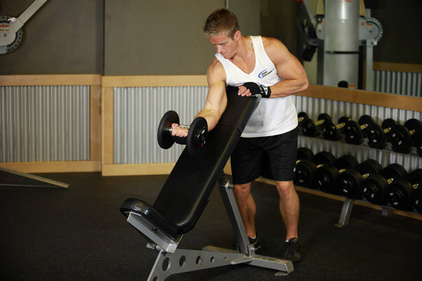 How to perform the Standing One-Arm Dumbbell Curl Over Incline Bench exercise