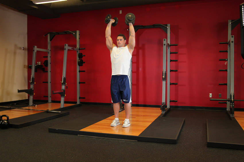 How to perform the Standing Palms-In Dumbbell Press exercise