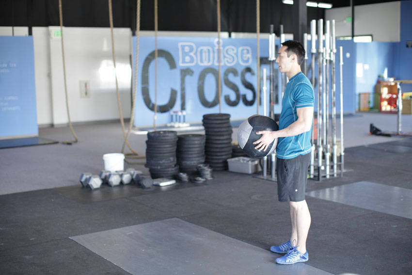 How to perform the Standing Two-Arm Overhead Throw exercise