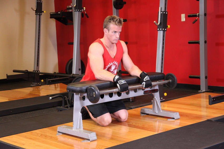 How to perform the Palms-Down Wrist Curl Over A Bench exercise