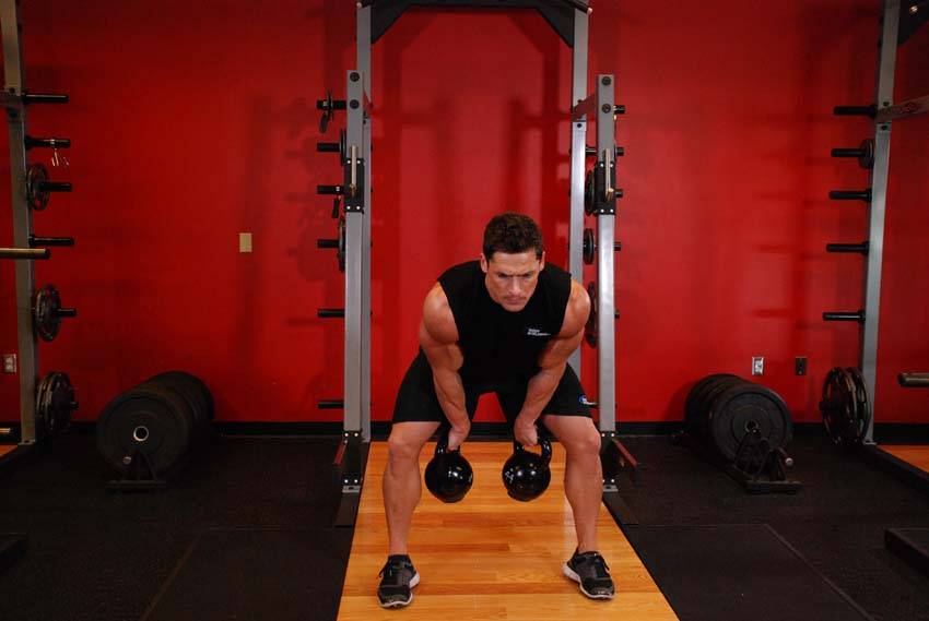 How to perform the Two-Arm Kettlebell Clean exercise